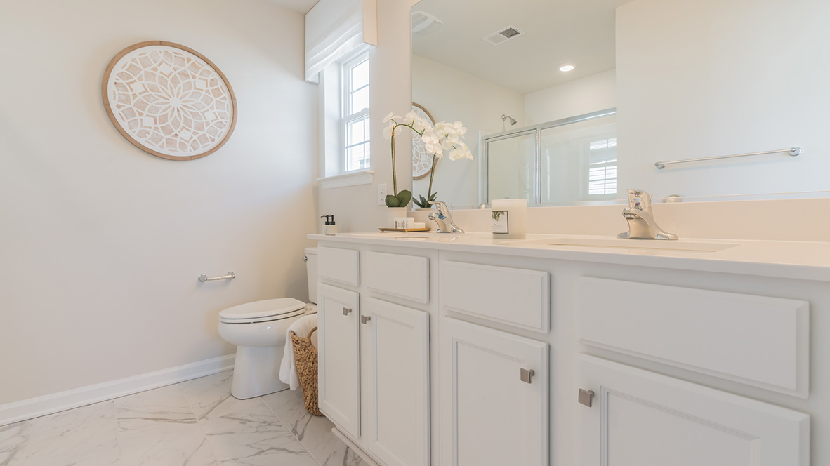 There is a private bathroom in the owner's suite with a double-bowl vanity.