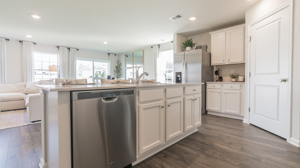 The home's well-designed kitchen with center island and corner pantry to the right.