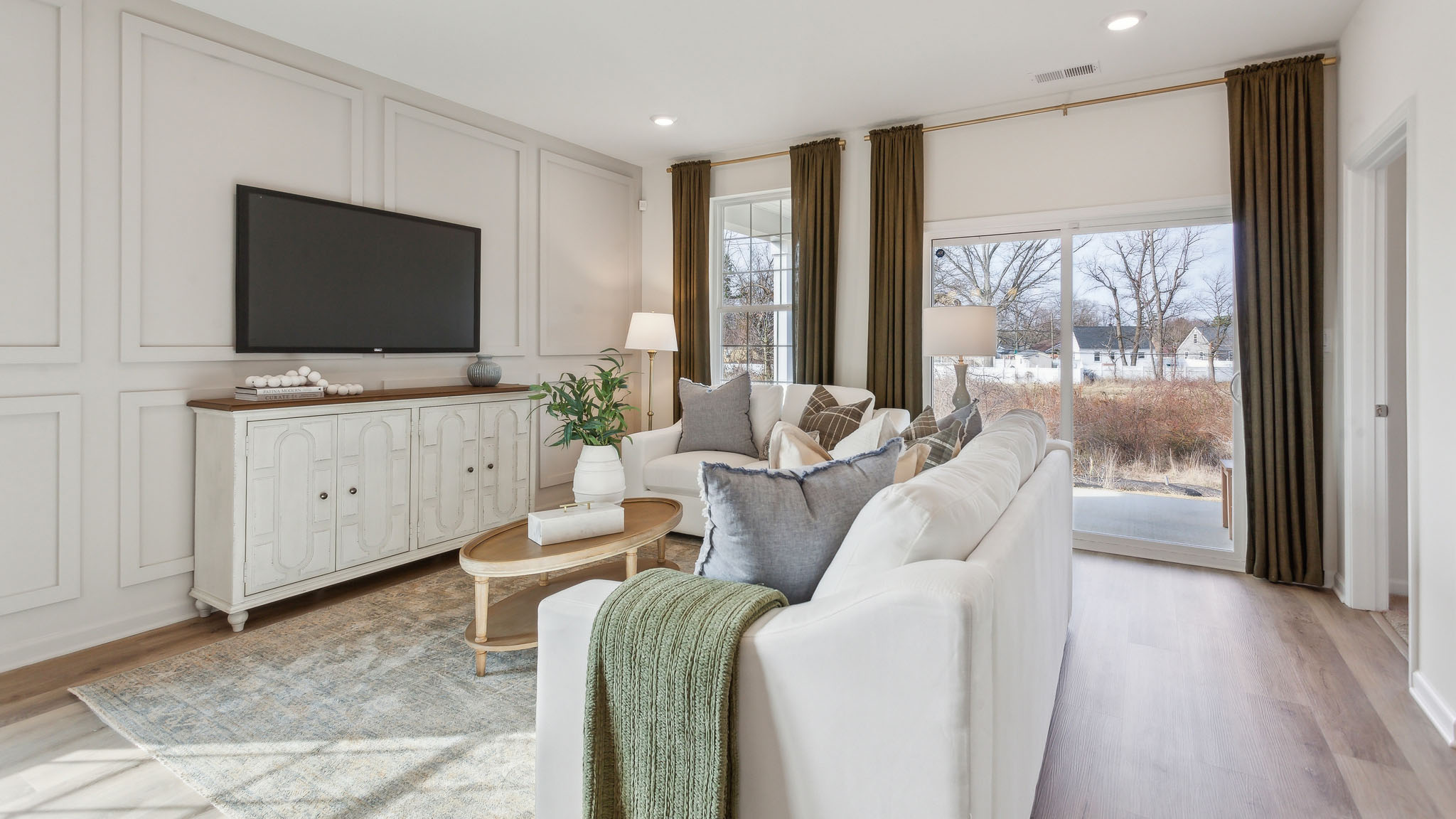 Laminate plank flooring continues into the cozy living area.