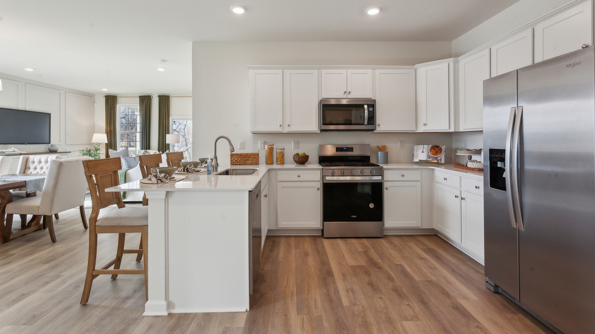 The open-concept kitchen features stainless steel appliances.