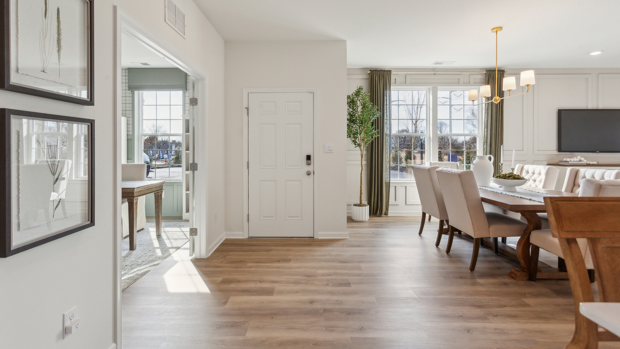 The front entryway with the open informal dining to the right and the den to the left.