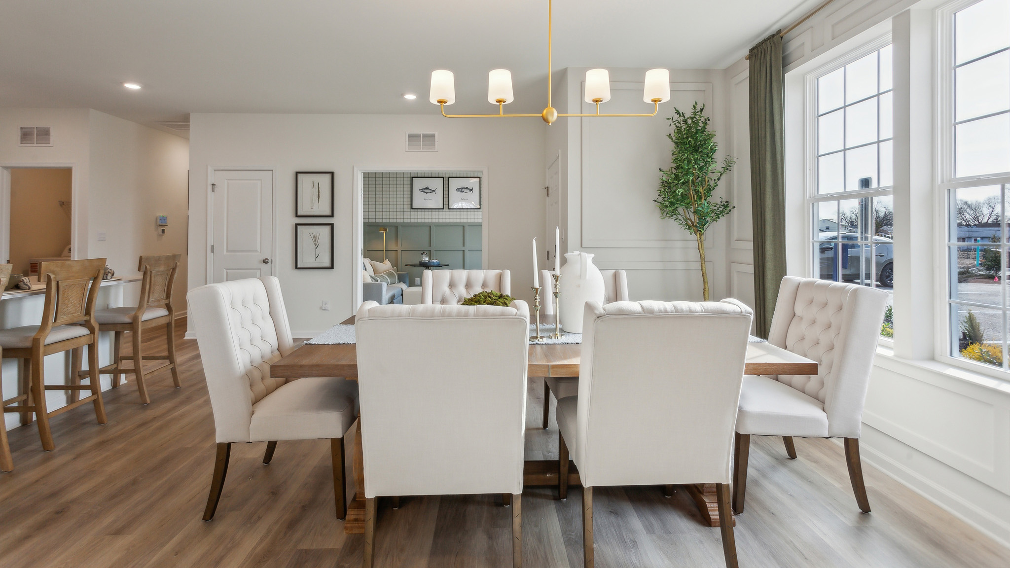The informal dining area has a double window and laminate plank flooring.