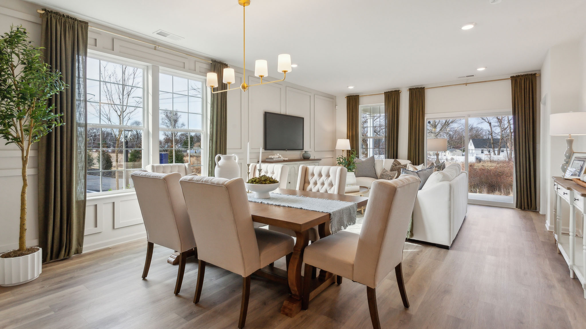 The informal dining area has a double window and laminate plank flooring.
