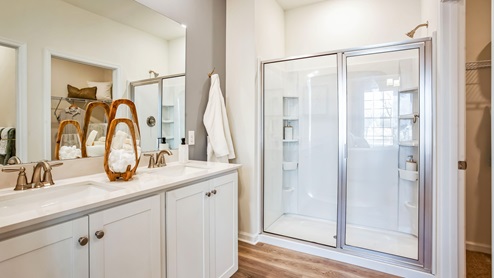 vThe primary bedroom has an en suite bathroom with walk-in shower.