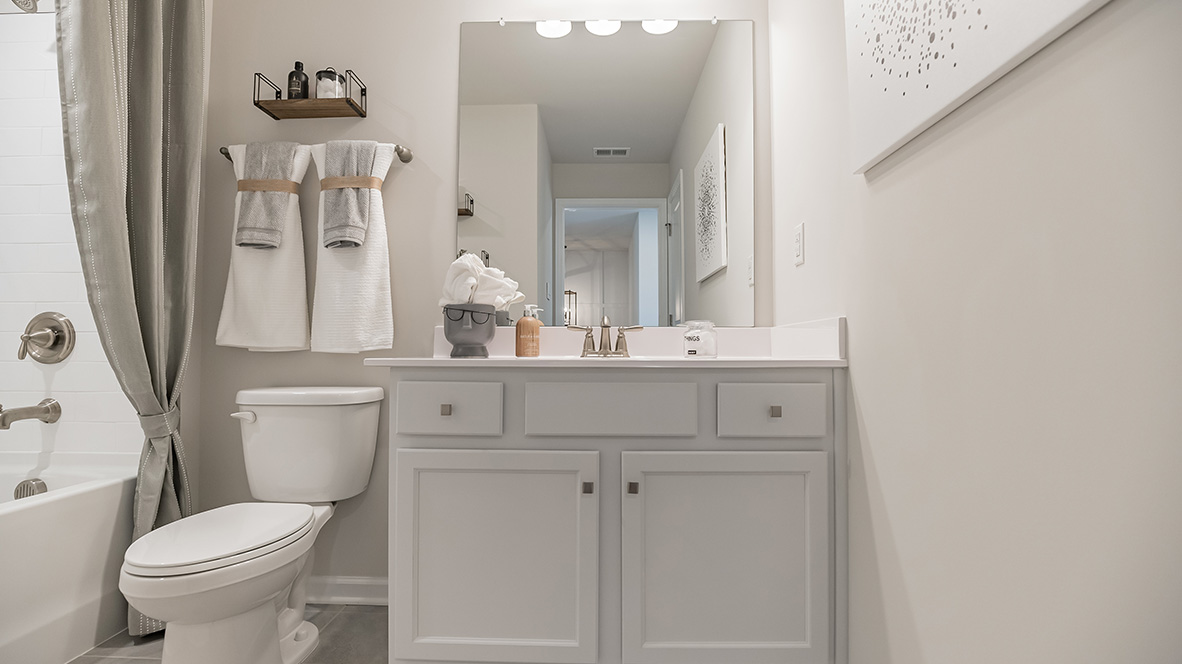 Different view of the secondary full bath on the second floor with single sink vanity and shower tub.