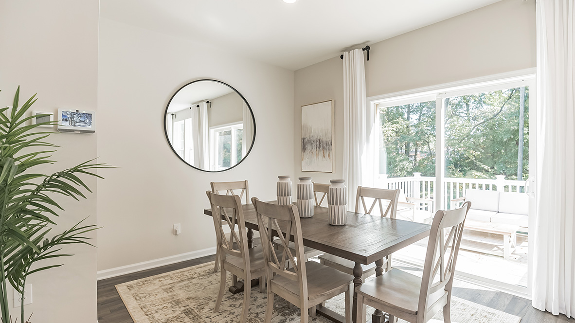 Dining area with peek into the back balcony deck.