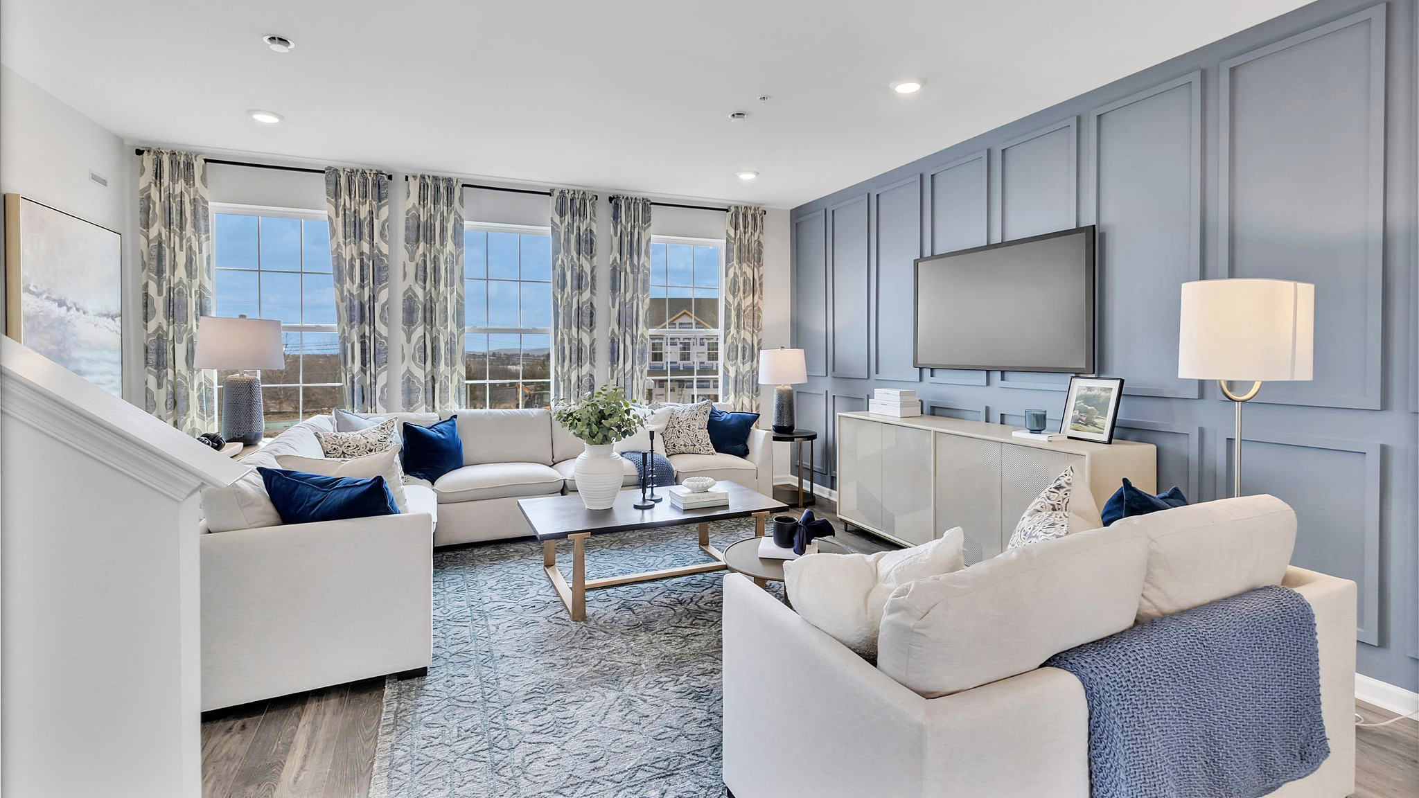 The living area with a TV mounted on the wall.