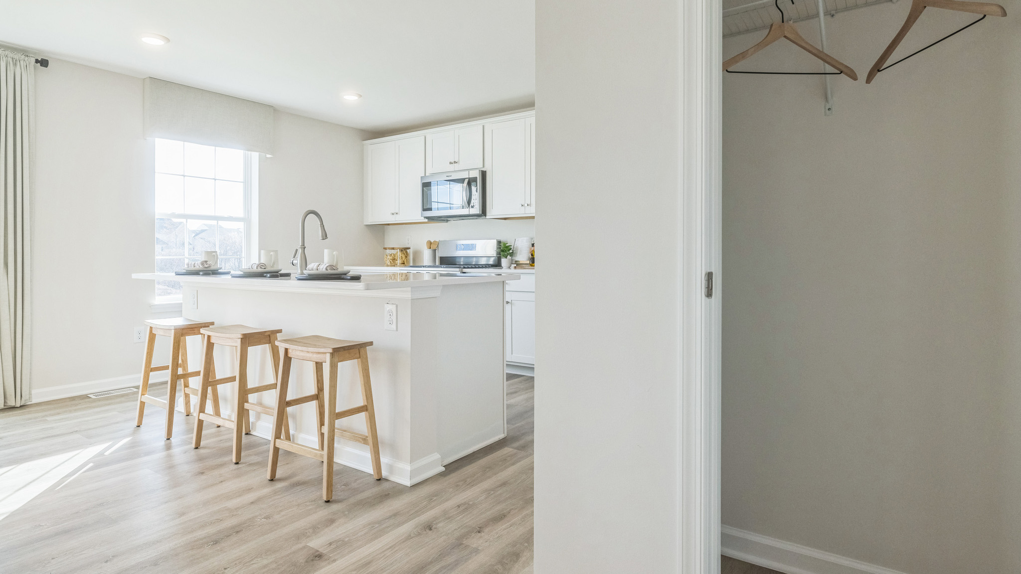 The coat closet is located off the kitchen.