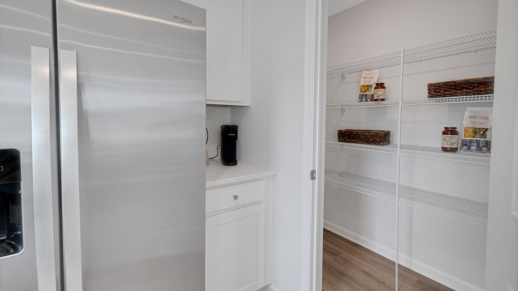 A sizeable pantry is in the corner of the kitchen.