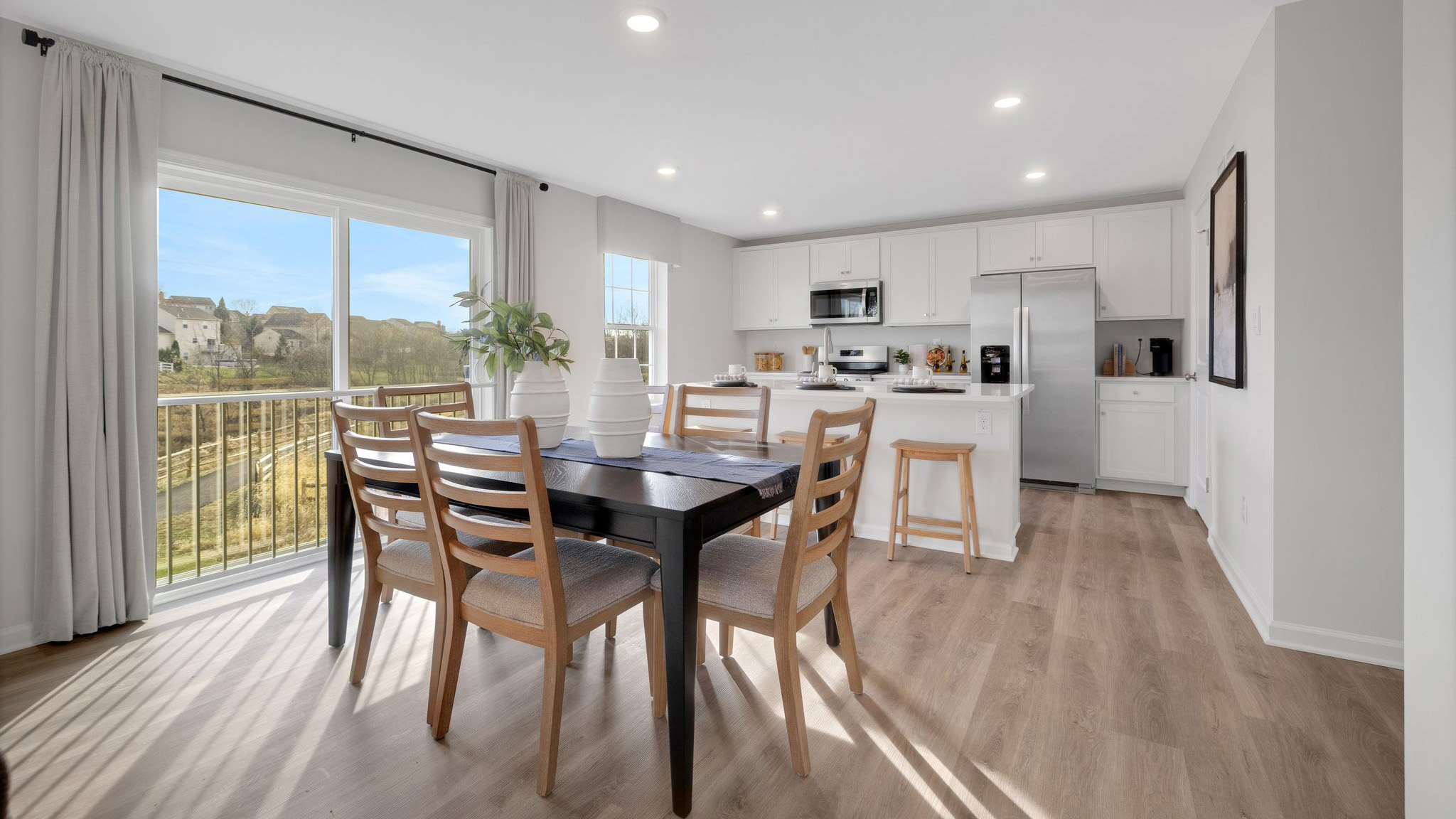 Dining area that overlooks sliding glass door to backyard.