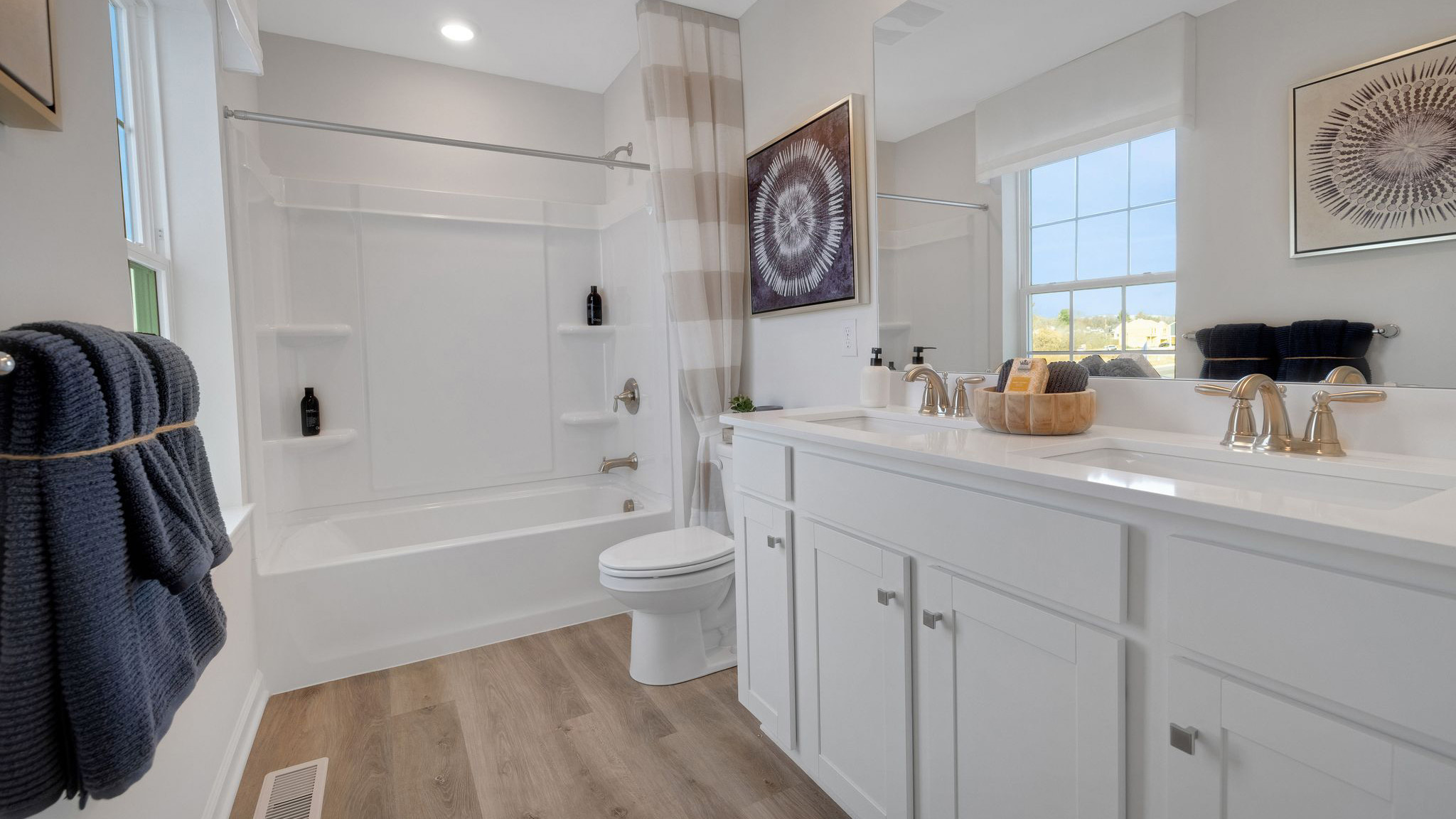 Secondary bathroom with shower, toilet and vanity.
