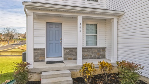 Lafayette Hills Twins Derby home with white primary siding, marine blue accent siding, and grey stone kneewall.