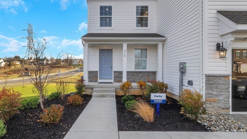 Lafayette Hills Twins Derby home with white primary siding, marine blue accent siding, and grey stone kneewall.