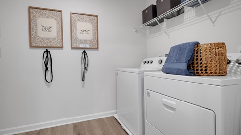 Laundry room has a lot of room for a folding table, ironing board, and more!