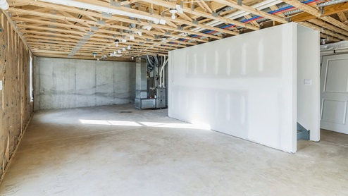 Massive unfinished basement with a sliding glass door is perfect for storage space.