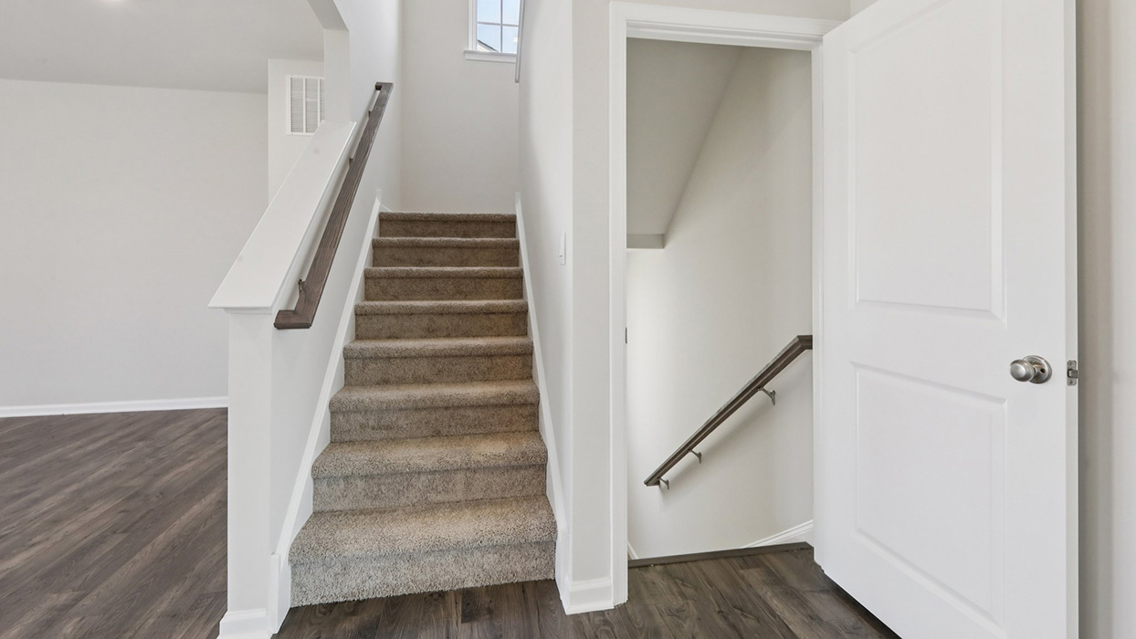 Main floor living level and view of the staircase to second floor