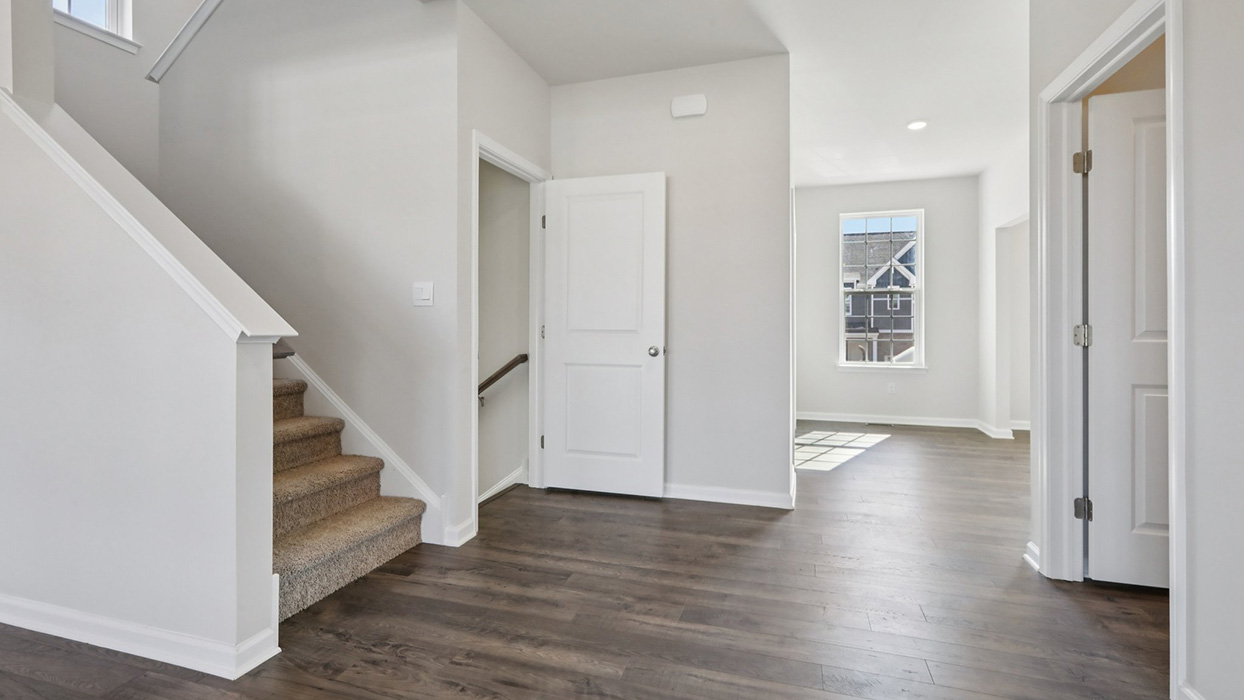 Open concept main floor living with view into the half bath.