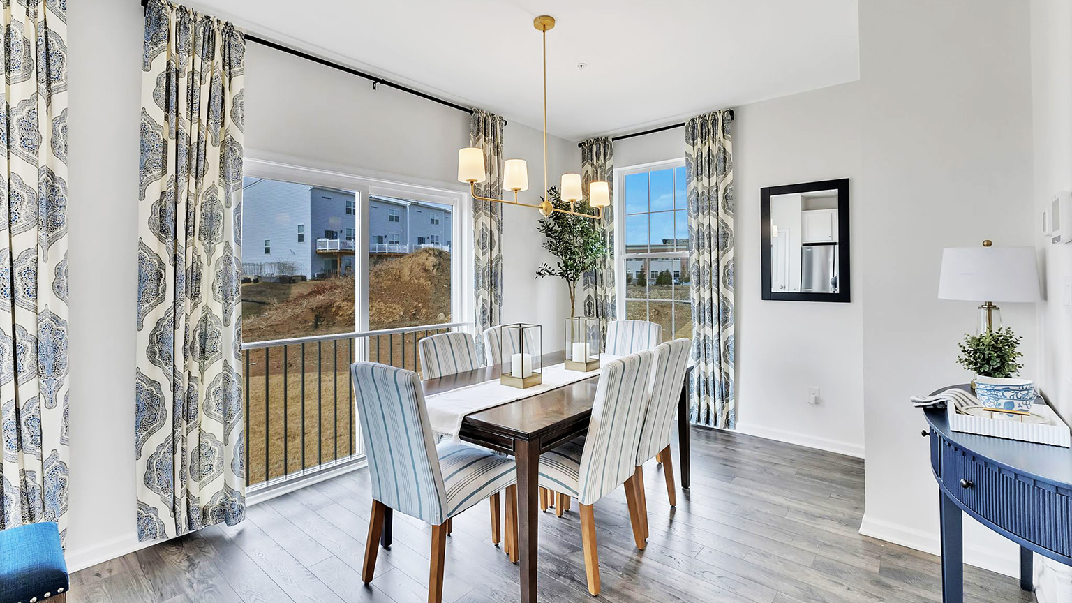 Dining area with peek into the back balcony deck.