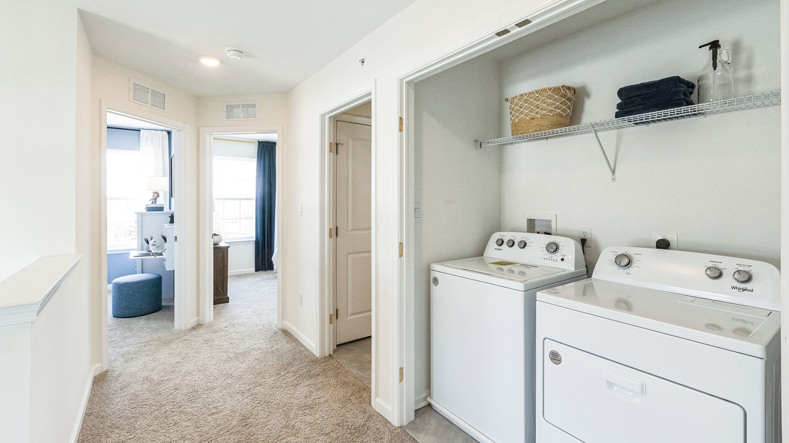 Laundry room with washer and dryer and shelf above.