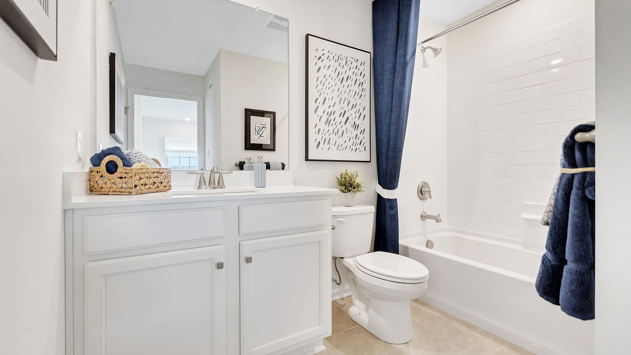 Secondary full bath on the second floor with single sink vanity and shower tub.