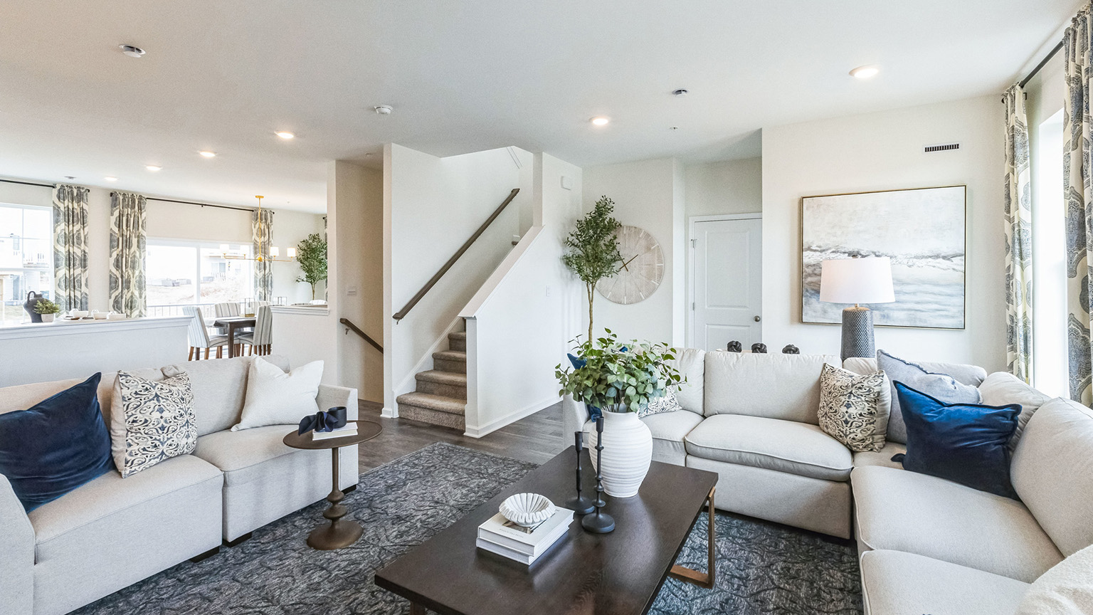 A different view of the living area with open layout with view of the stairs.