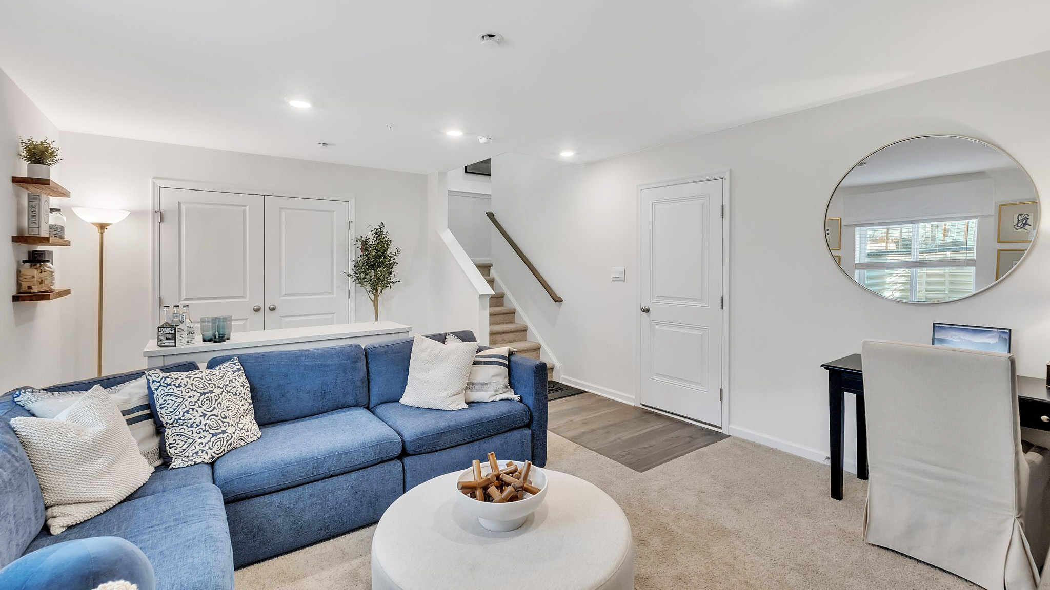 Lower level recreation room with double doors to the utility room and back sliding glass door to the backyard.