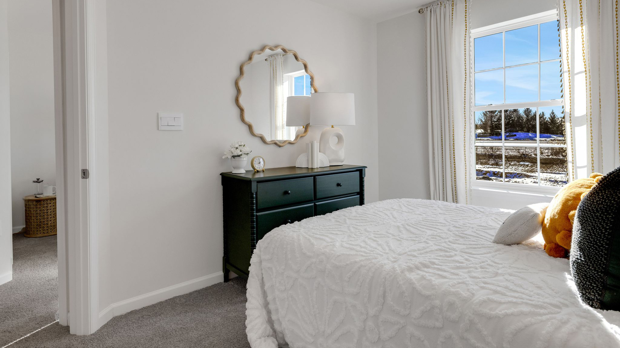 Bedroom three has a small dresser with lamp.