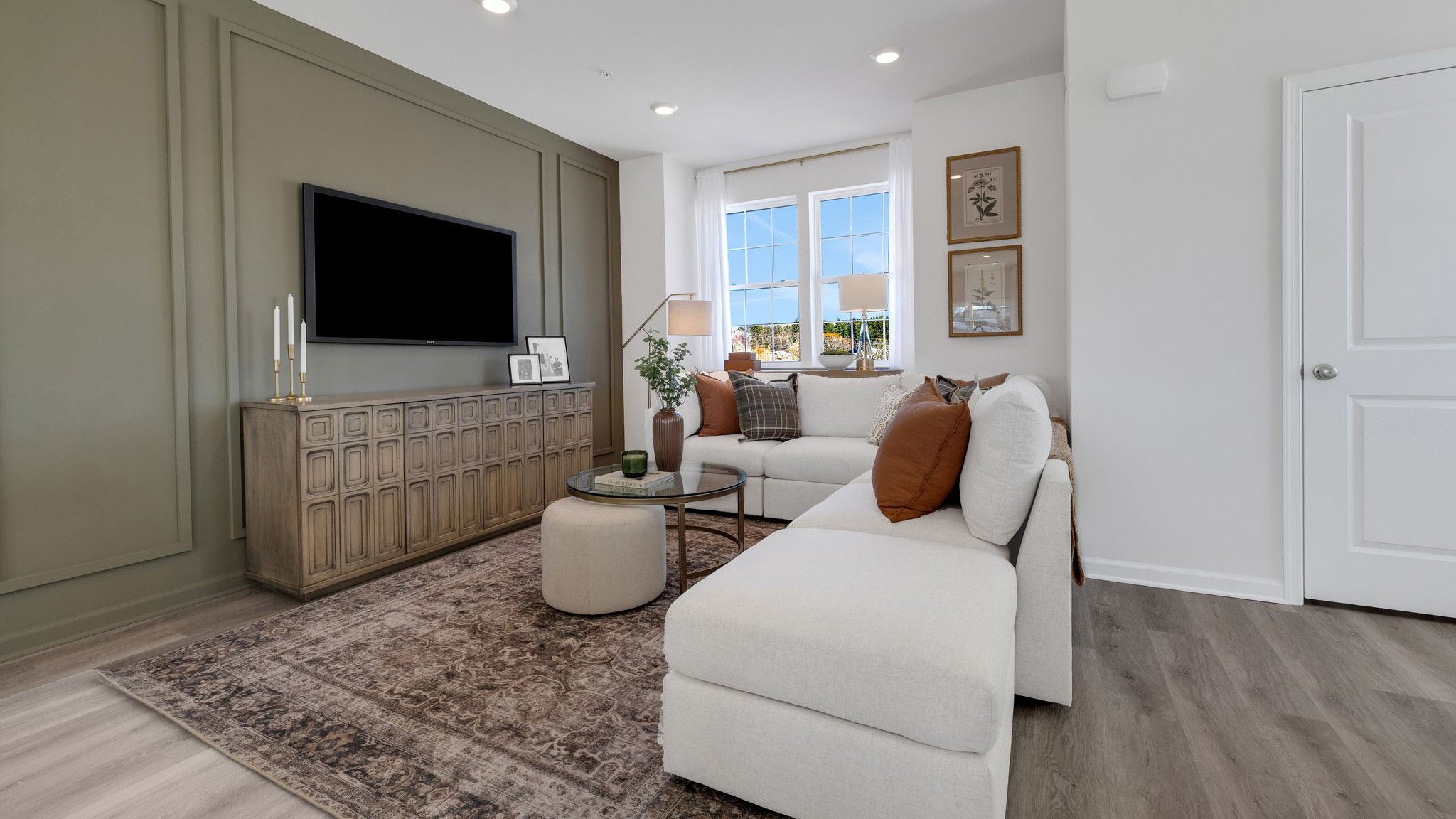 Living room area with a TV mounted on the wall.