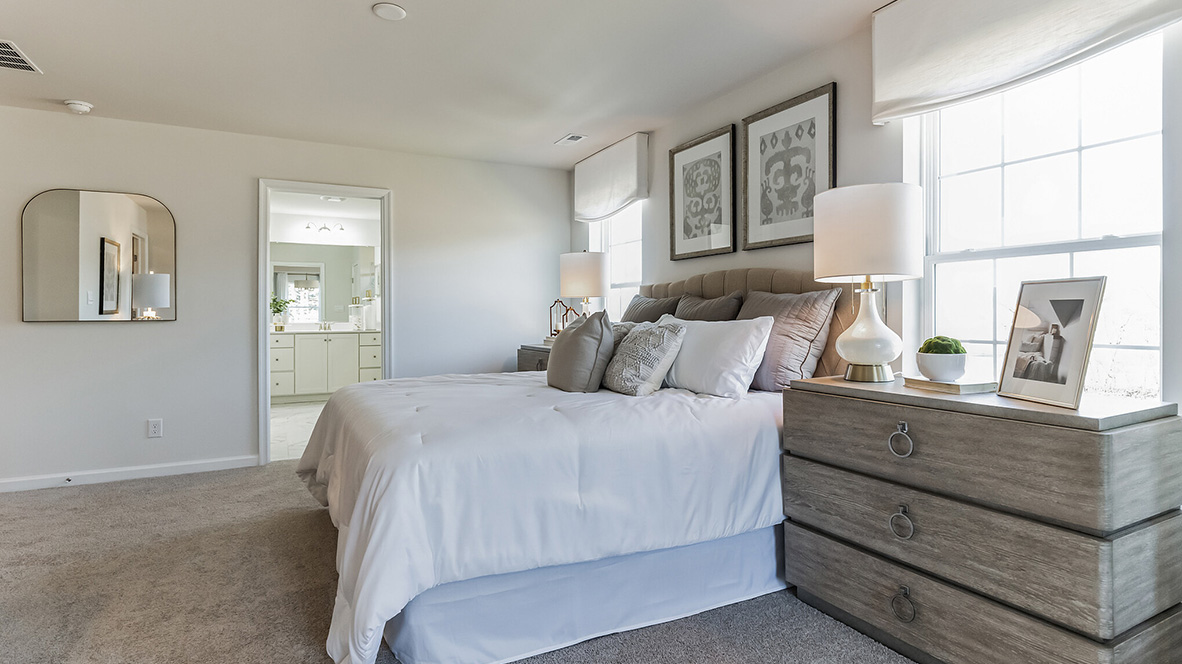 Owner's suite with peek into connecting bathroom.
