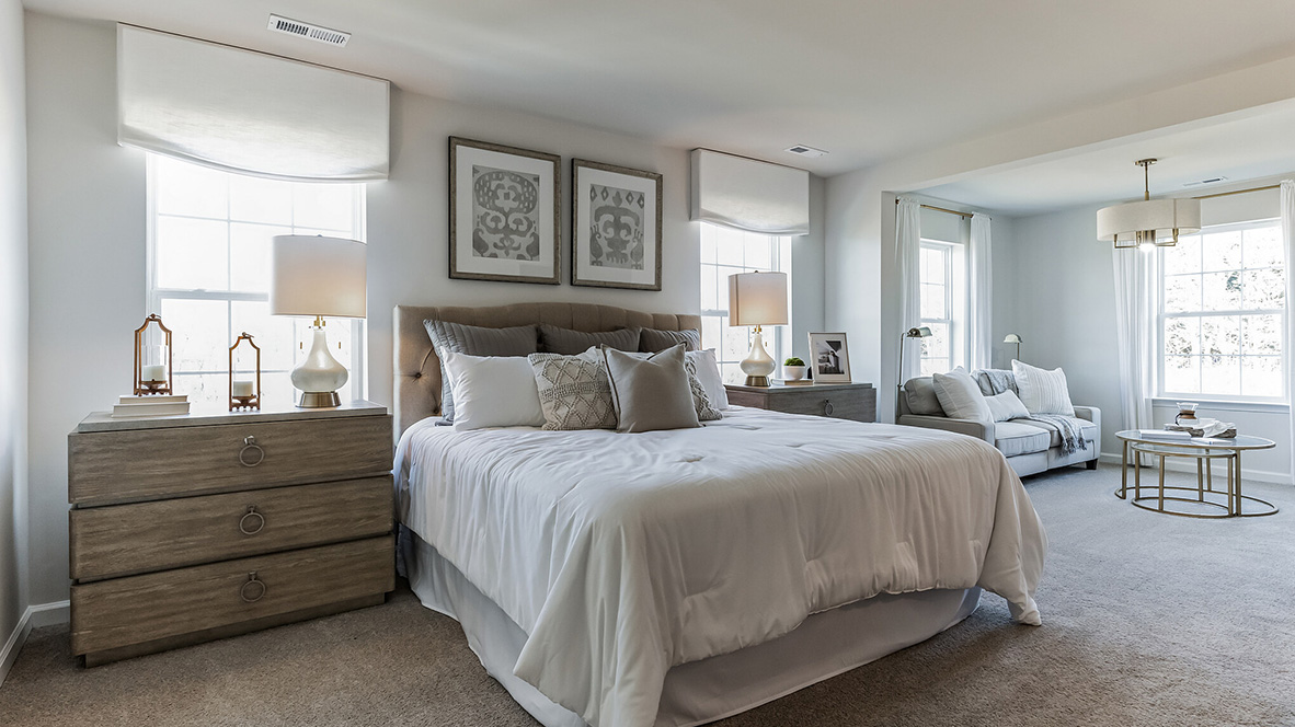 Owner's suite with peek into connecting bathroom.