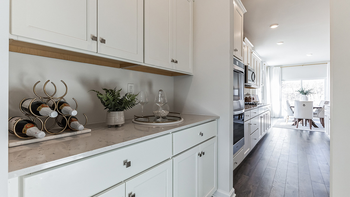 Built in bar of coffee nook in the hall between the kitchen and the ding room. The area is directly across from the pantry.