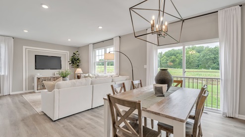 Open area between kitchen and living area with room for dining table.