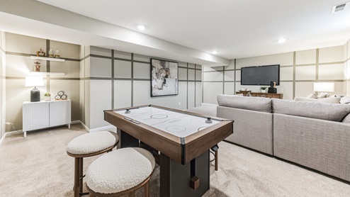 Open room with carpeted floors and accent walls.