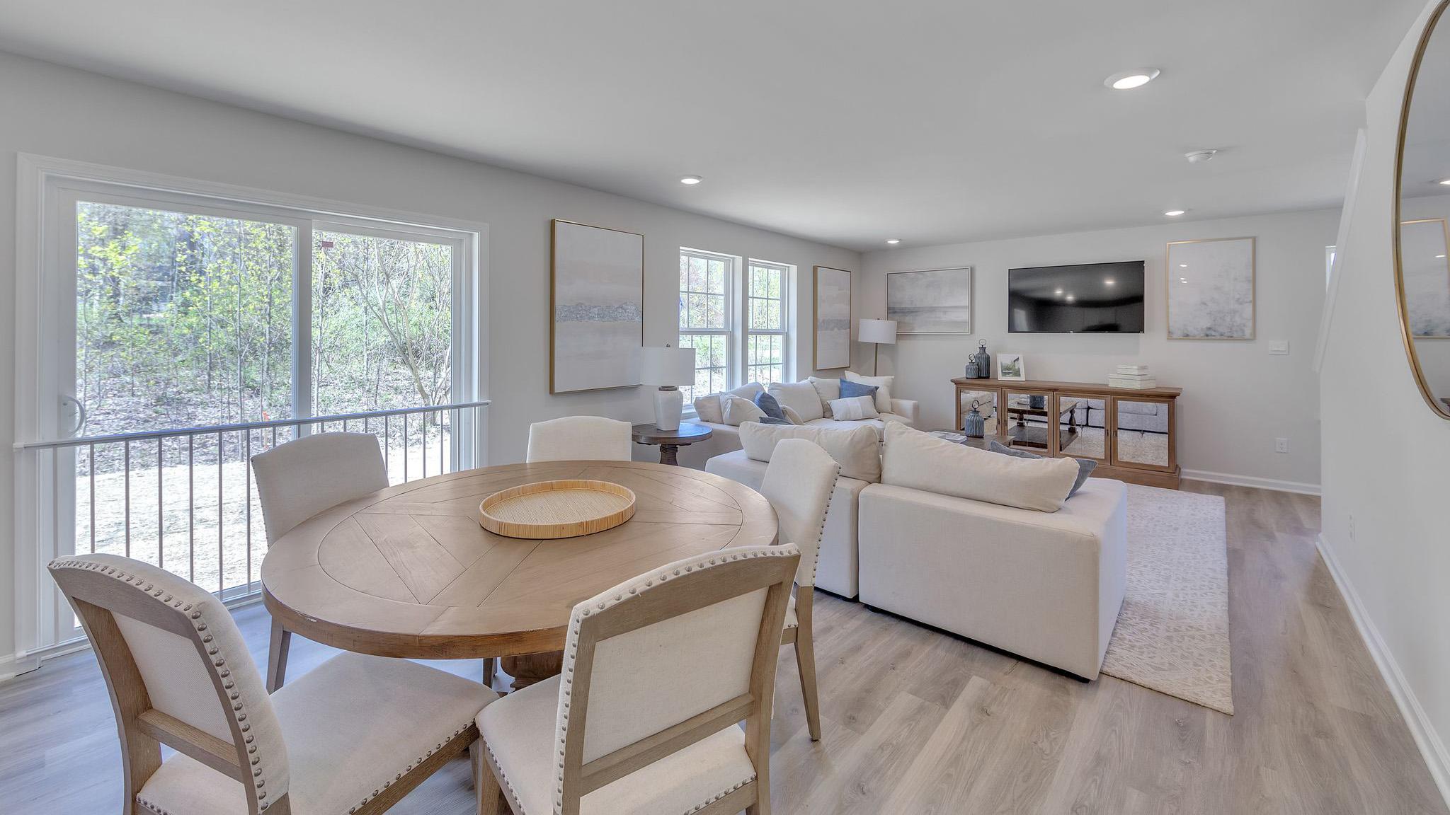 Dining area that overlooks sliding glass door to backyard.