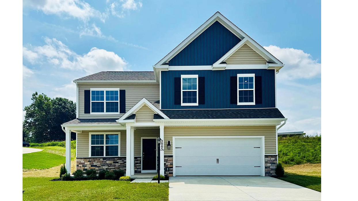 Strawberry Field Estates Henley with linen and dark blue siding, black shutters, and a white two-car garage.