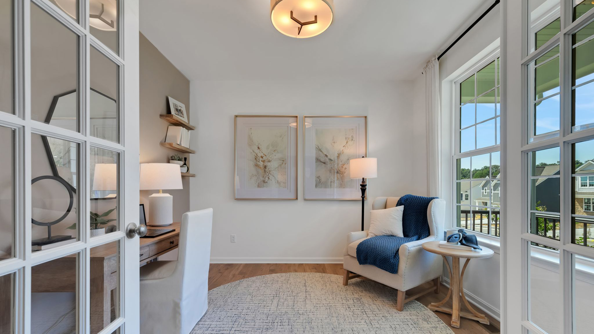 Reserve at Lakeside Henley home with blue and white siding, stone kneewall, light blue front door.