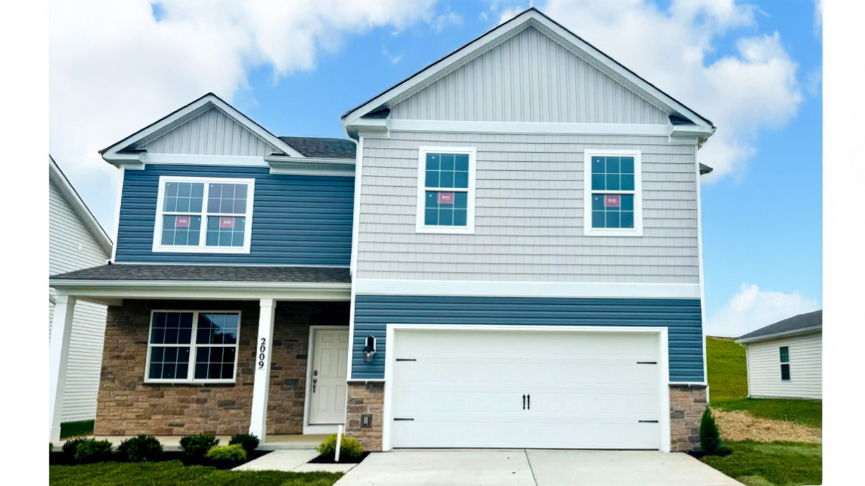 An image of a two-story Henson home with storm blue siding, shake accent siding in sterling, stone siding surrounding the porch and a stone kneewall surrounding a white two car garage.