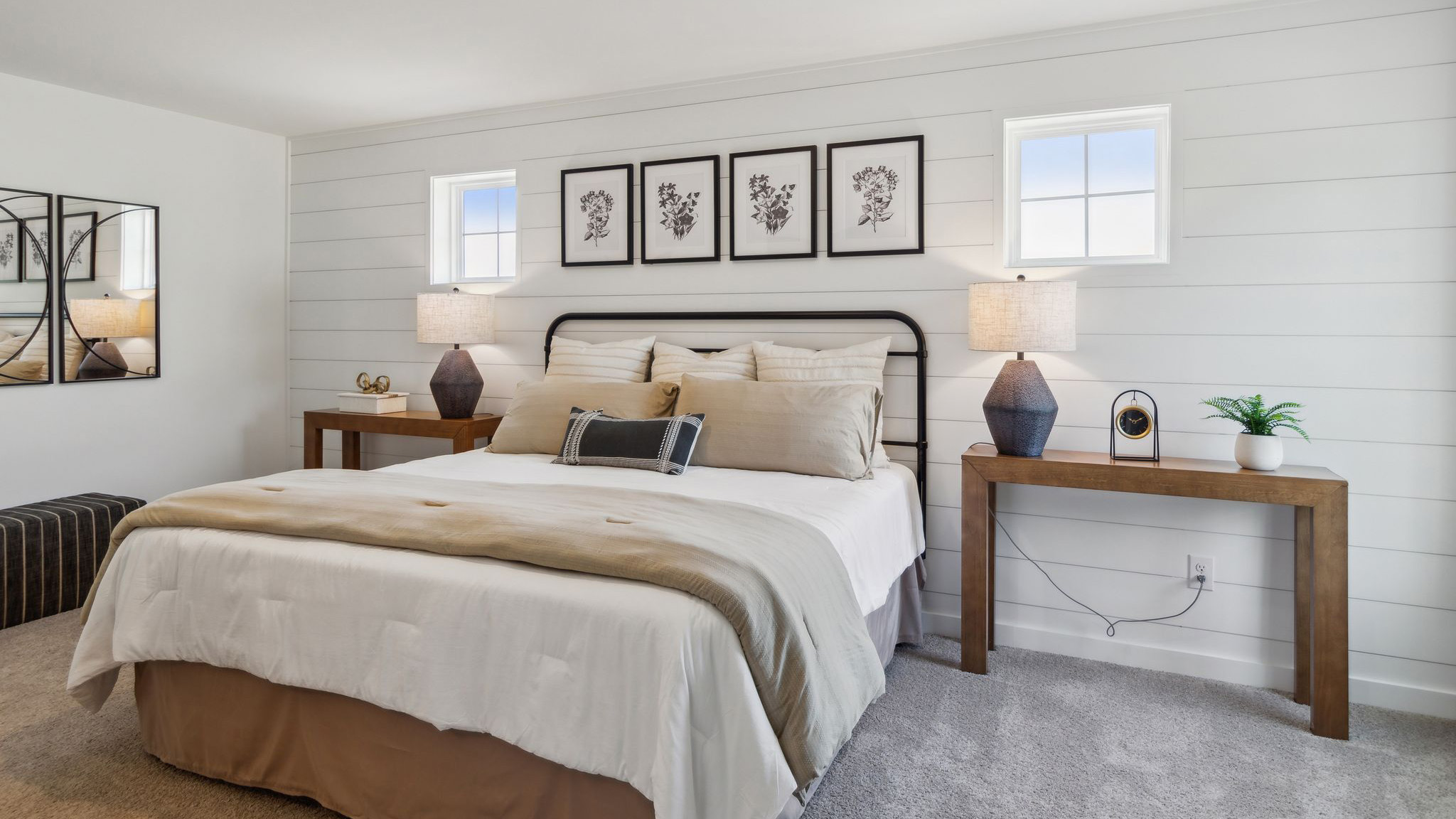 Different view of the bedroom with two small high windows on either side of the bed.