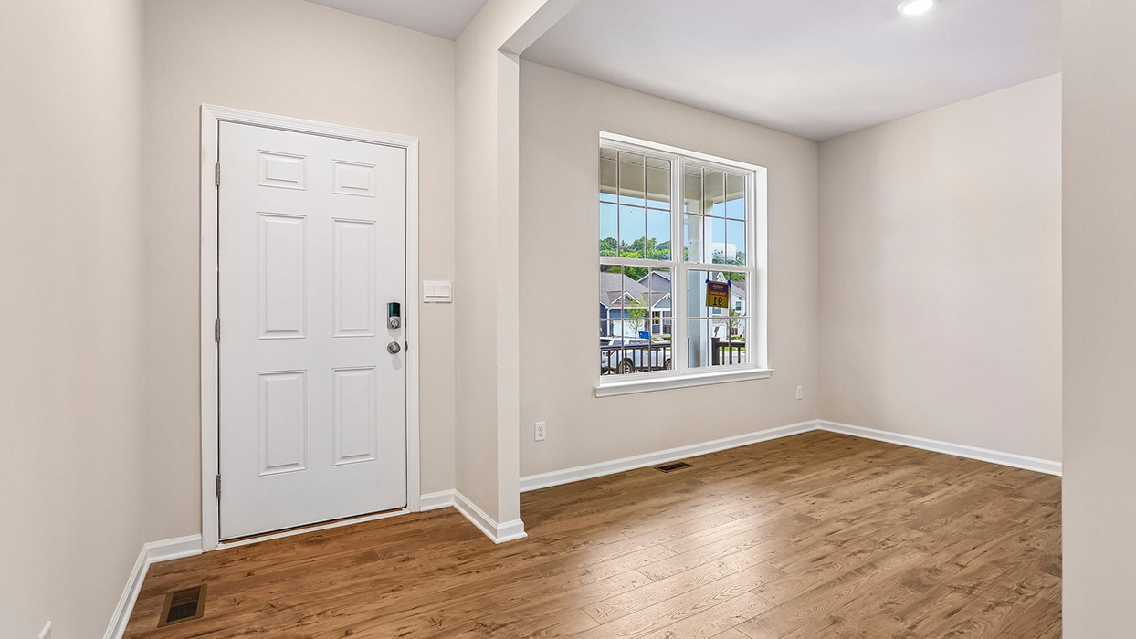 Welcoming entry area with a flexible front living space, offering opportunities for a home office, sitting room, or additional gathering area.