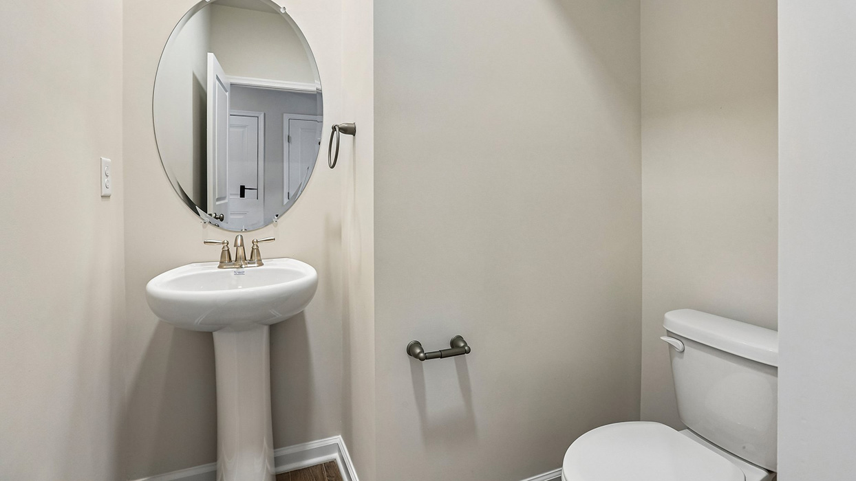Convenient main-level powder room designed to provide comfort and accessibility for guests and everyday use.