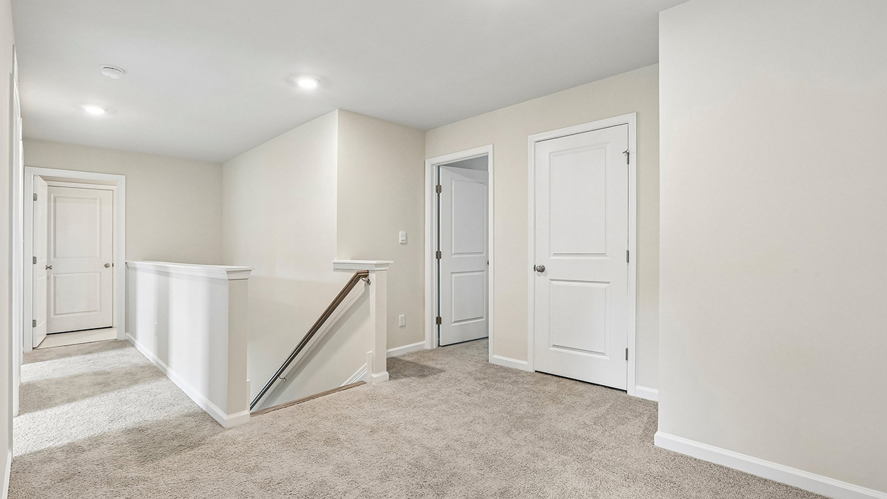 Open upper-level hallway providing easy access to bedrooms and shared living spaces while enhancing the home's functional layout and flow.
