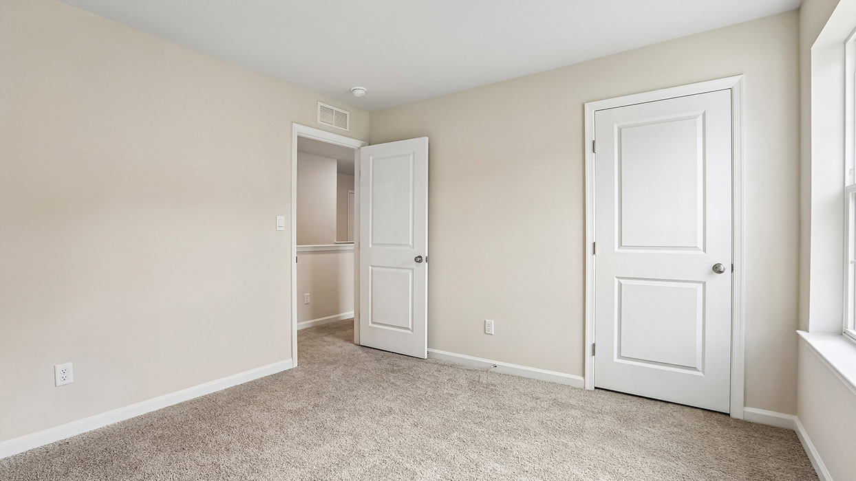 Well-sized bedroom offering a versatile layout, convenient closet storage, and room to adapt to changing needs over time.