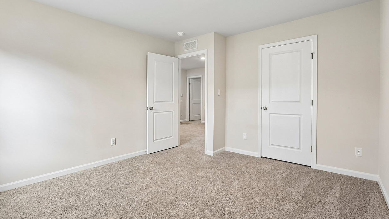 Secondary bedroom with convenient closet access and adaptable space to accommodate a variety of household uses.