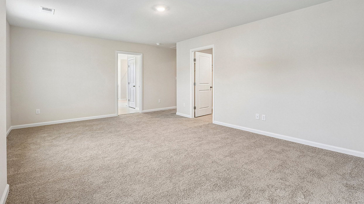 Spacious upper-level loft designed to provide additional room for entertainment, relaxation, and evolving household needs.
