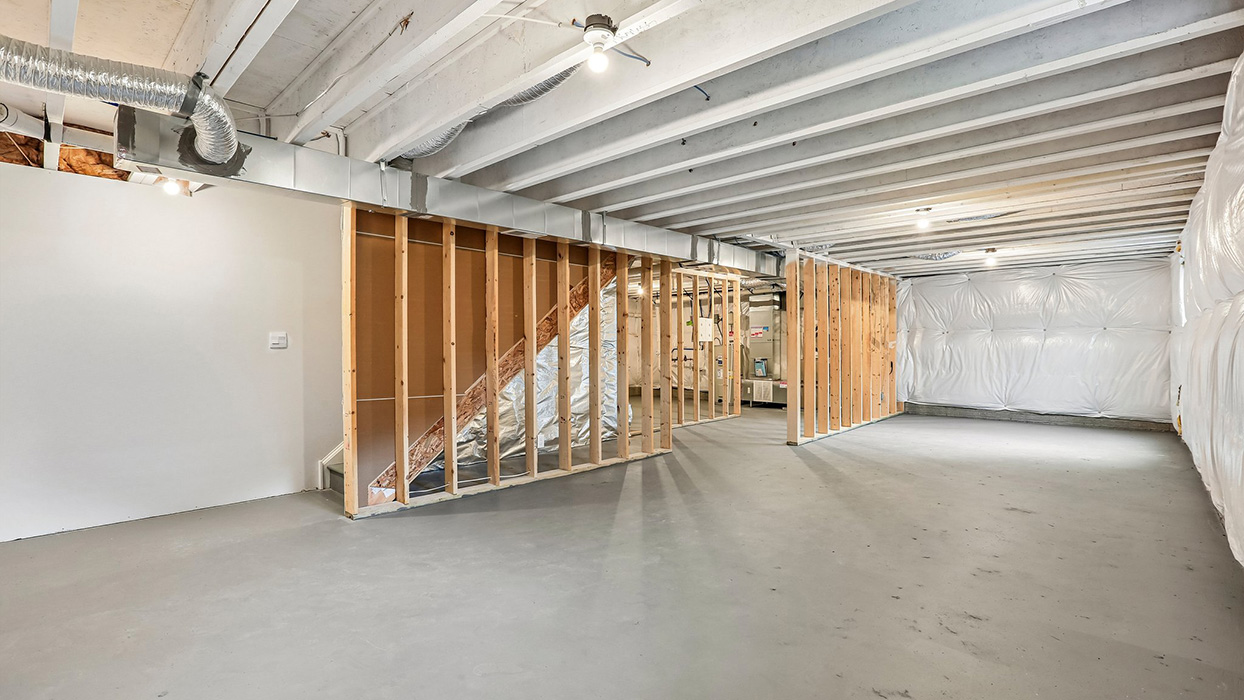 Unfinished basement with expansive square footage and endless potential for future living space, recreation, fitness, storage, or hobby areas.