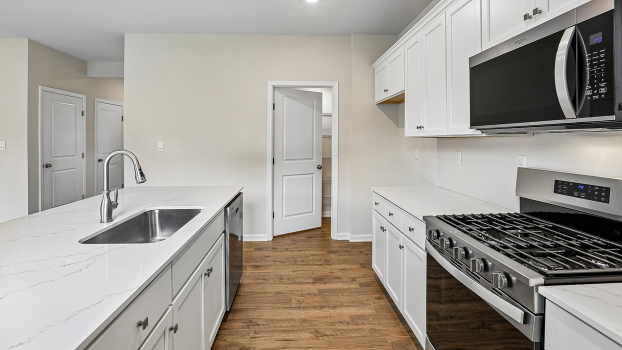 Open kitchen with expansive prep space, ample cabinetry, and convenient access to nearby living and dining areas.
