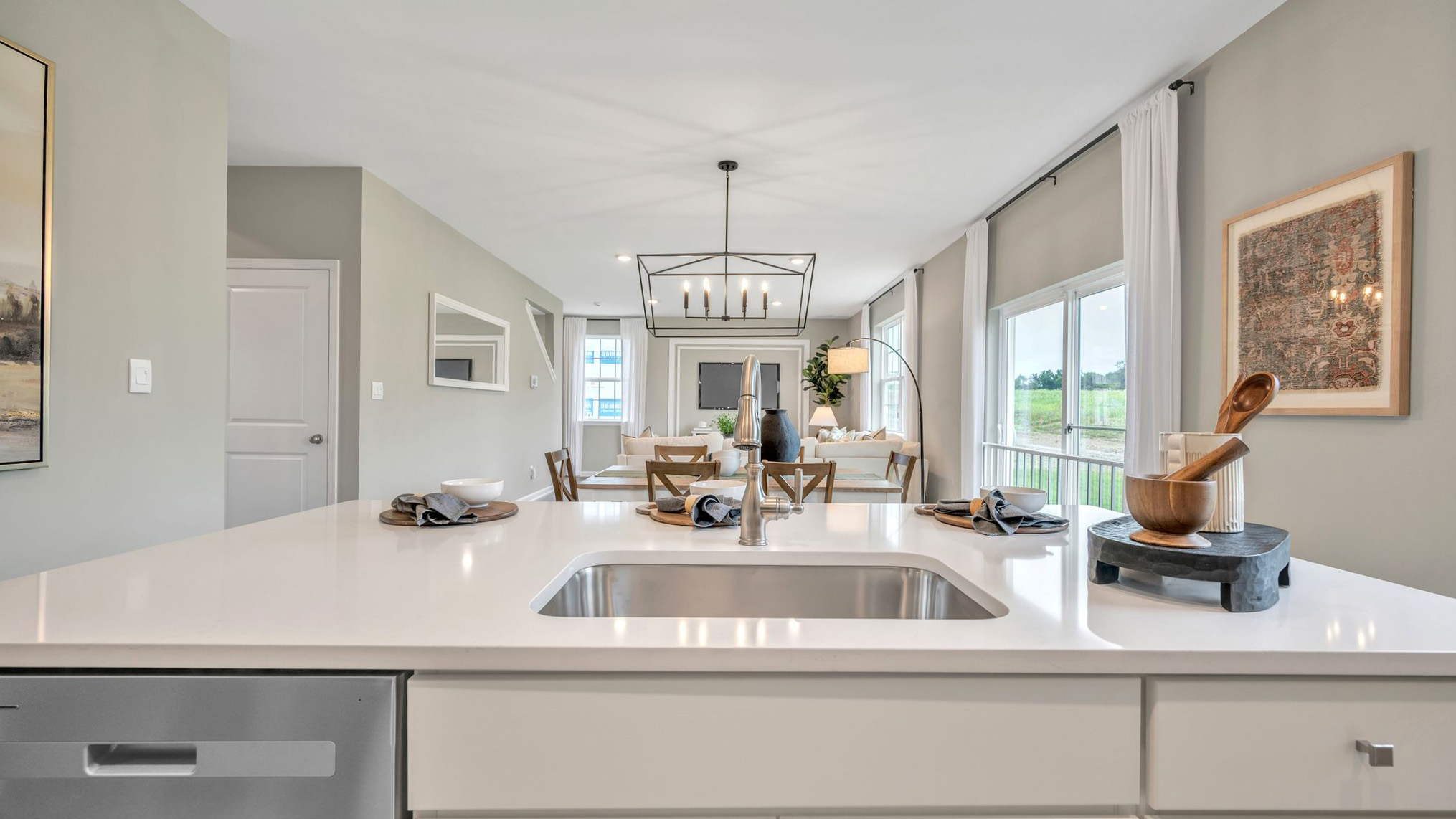 The kitchen island features a single sink.
