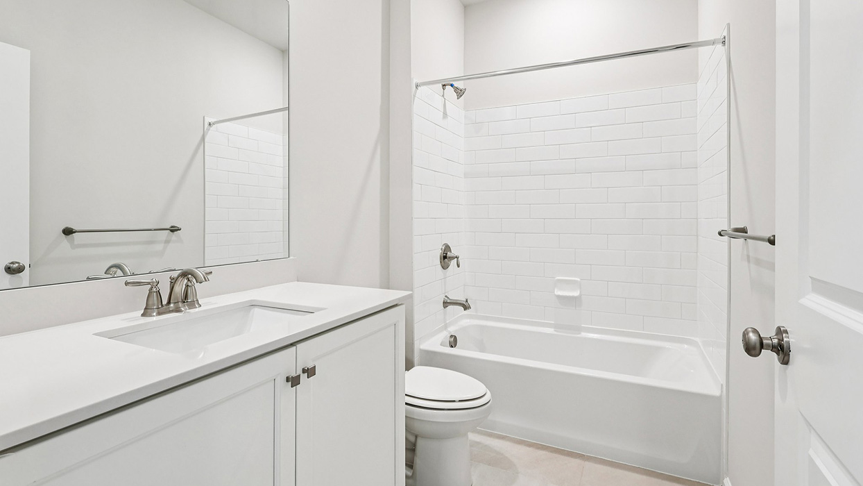 Bathroom two with single vanity and white vanity and bathtub