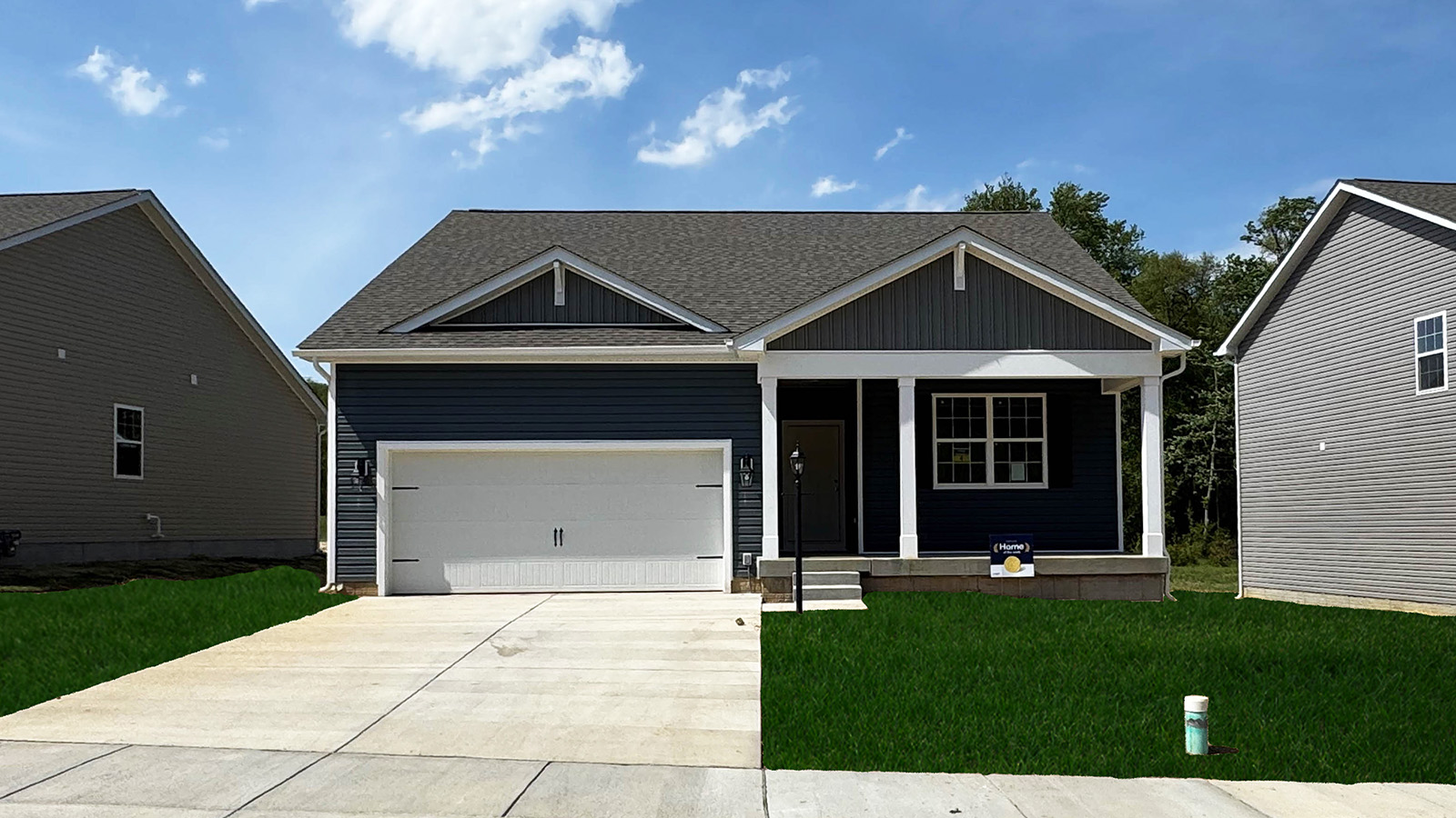 Reserve at Lakeside Hamilton plan with dark blue siding, white trim, and two car garage