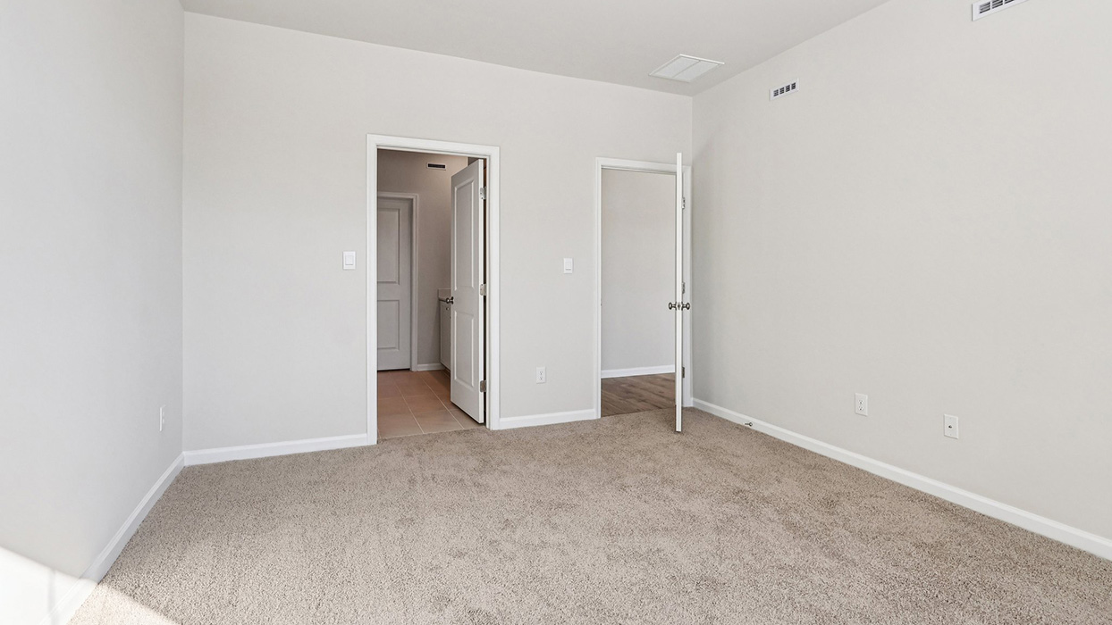 A different view of the primary bedroom with walk in closet